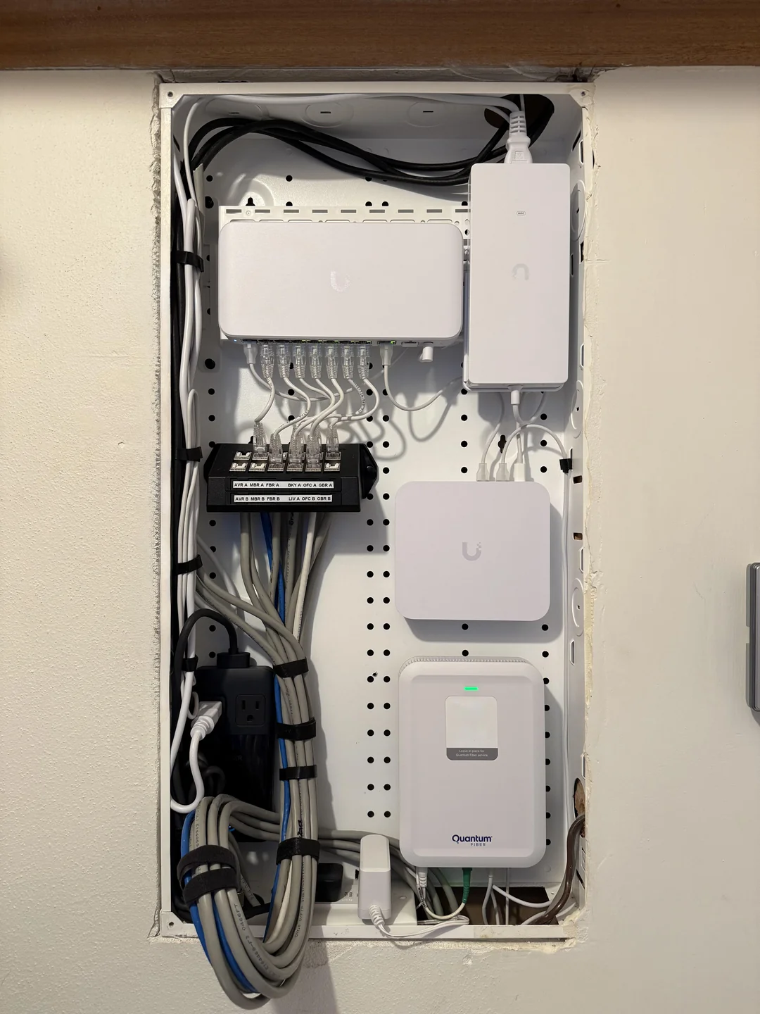 Finished 2.5-gigabit home network rack with patch panel, PoE switch, and labeled drops