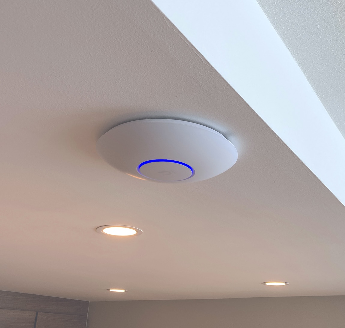 UniFi access point installed on a ceiling